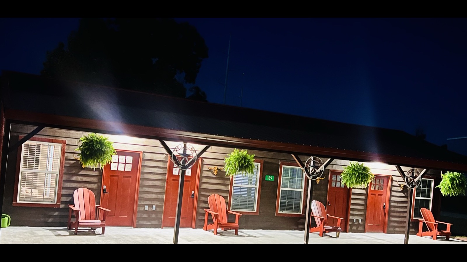Club Lakeland Resort cabins with red chairs on a warm Grand Lake evening